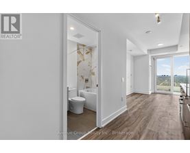 A bathroom with a toilet, sink, and a window overlooking a balcony.