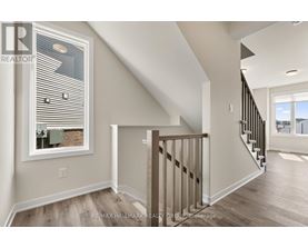A spacious room with a staircase leading to another room.