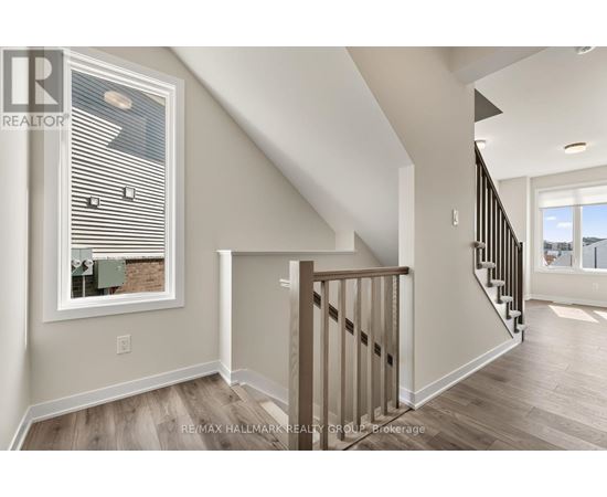 A spacious room with a staircase leading to another room.