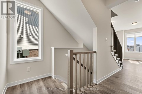 A spacious room with a staircase leading to another room.