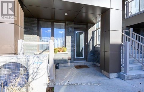 The image shows the front of a building with the number 14 on it.