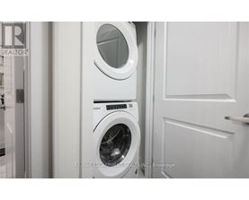 A white washing machine and dryer in a laundry room.