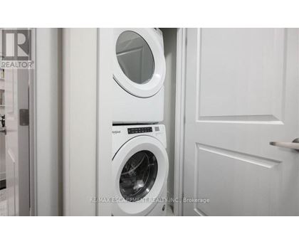 A white washing machine and dryer in a laundry room.