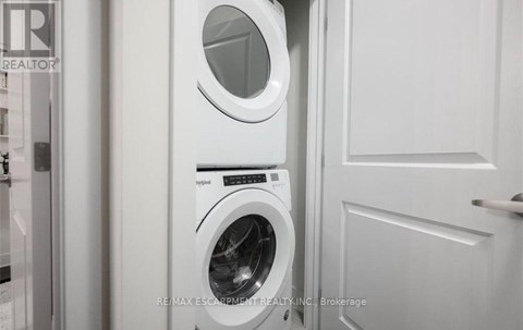 A white washing machine and dryer in a laundry room.