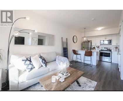 A modern living room with a white couch and a wooden coffee table.