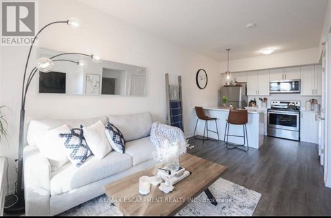 A modern living room with a white couch and a wooden coffee table.
