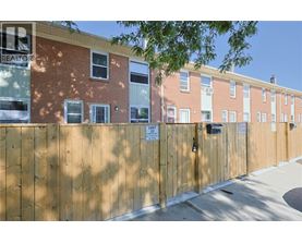 A brown fence with a sign that says "Unit 22".