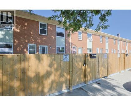 A brown fence with a sign that says "Unit 22".