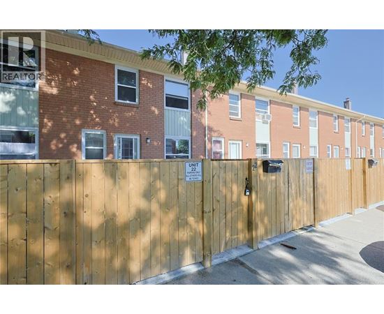 A brown fence with a sign that says "Unit 22".