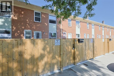 A brown fence with a sign that says "Unit 22".