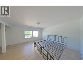 A bedroom with a bed and a window.