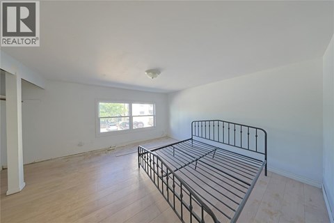 A bedroom with a bed and a window.