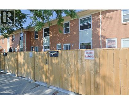 A wooden fence with a sign that says "VISITOR PARKING" on it.
