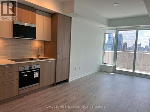 A kitchen with wooden cabinets and a black stove top oven.