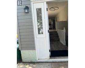 A white door with a glass window is open.