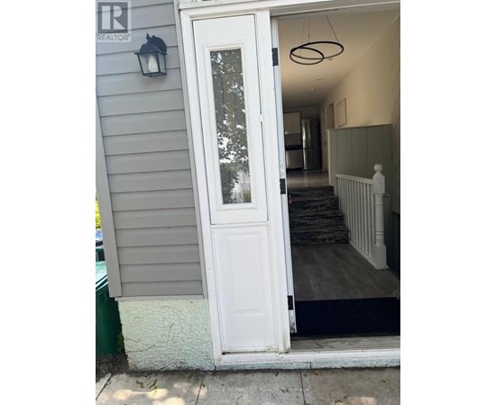 A white door with a glass window is open.