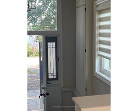 A white door with a glass window and a black handle.