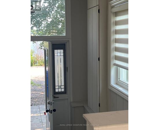 A white door with a glass window and a black handle.