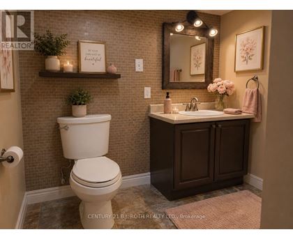 A bathroom with a toilet, sink, and mirror.
