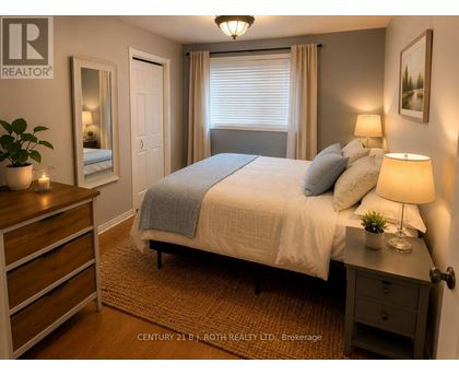 A bedroom with a bed, nightstand, and dresser.