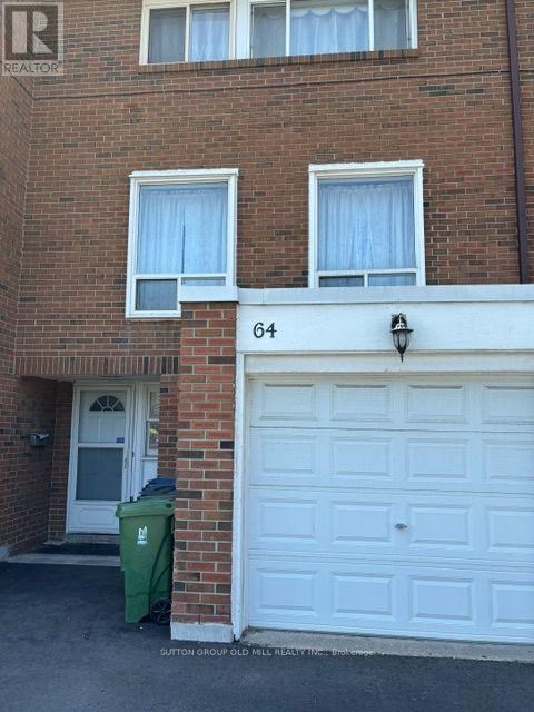 A brick building with the number 64 on the front.