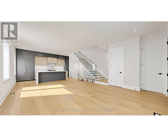 A spacious living room with a staircase leading to the upper floor.