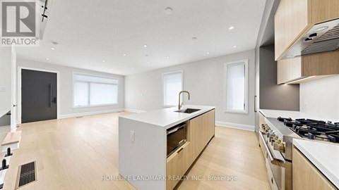 A modern kitchen with wooden cabinets and a central island.
