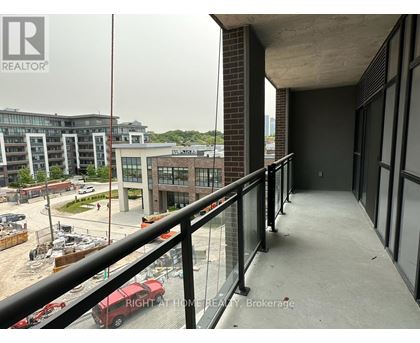 A balcony with a railing overlooks a construction site.