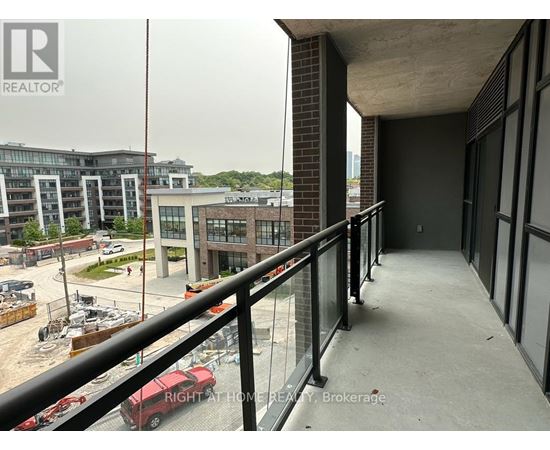 A balcony with a railing overlooks a construction site.