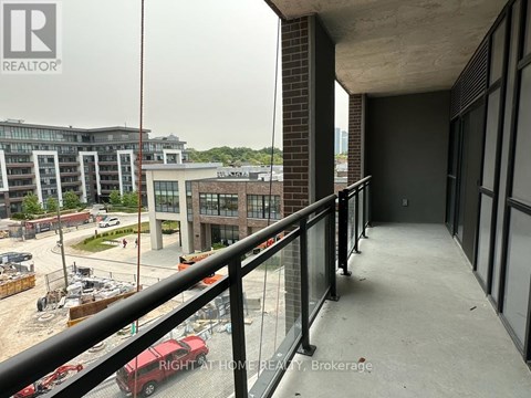 A balcony with a railing overlooks a construction site.
