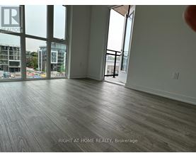 A room with a view of a construction site through the windows.