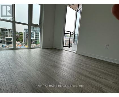 A room with a view of a construction site through the windows.