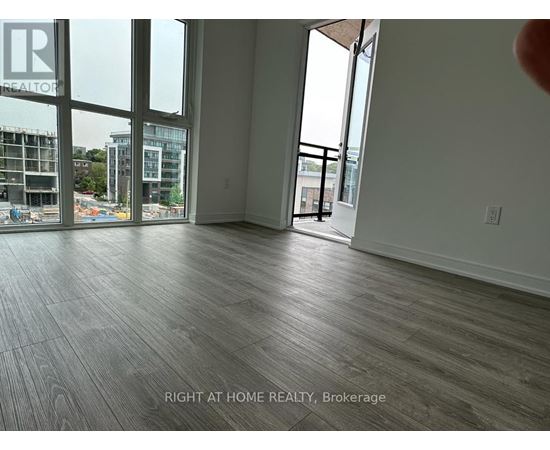 A room with a view of a construction site through the windows.