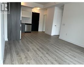 A room with a wooden floor and white walls.