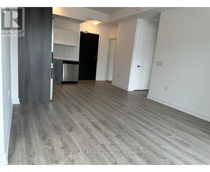A room with a wooden floor and white walls.