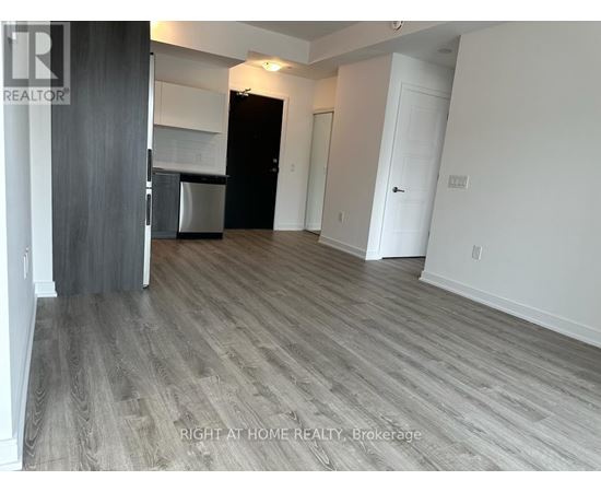 A room with a wooden floor and white walls.