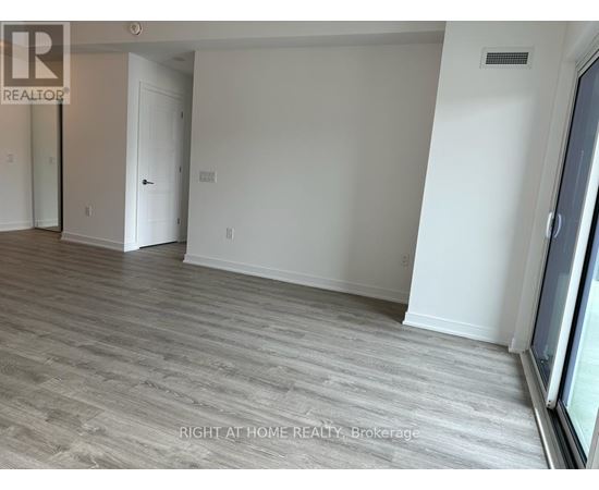 A room with a grey floor and white walls.