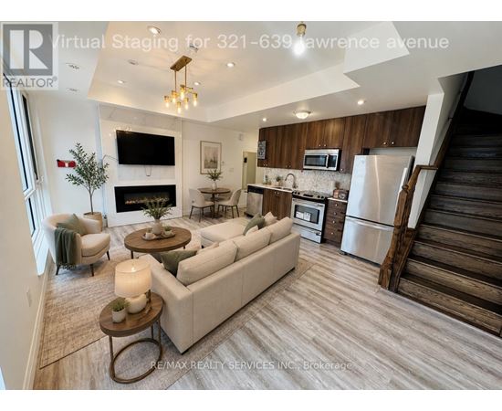 A modern living room with a staircase on the right side.