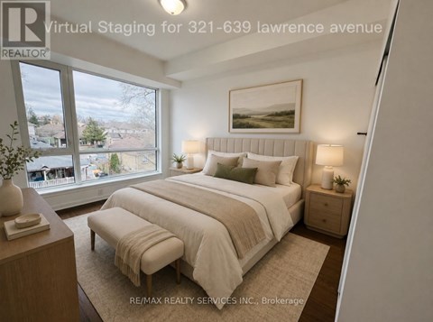 A bedroom with a large bed and a window overlooking a residential area.