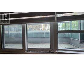 A window with a view of a building and trees outside.