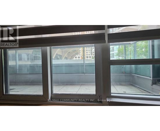 A window with a view of a building and trees outside.