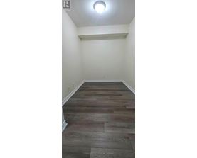 A room with a wooden floor and white walls.