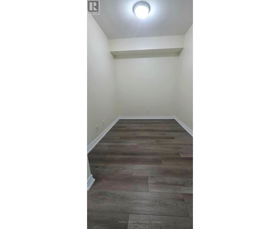 A room with a wooden floor and white walls.