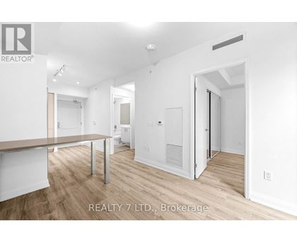 A spacious room with a long table and chairs is available for rent.