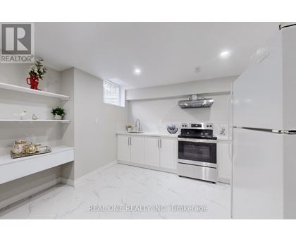 A white kitchen with a refrigerator, oven, and shelves.