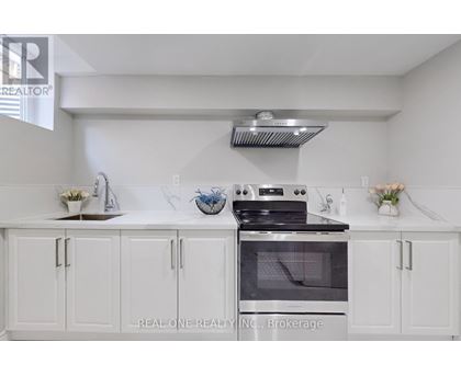 A white kitchen with a stove and cabinets.