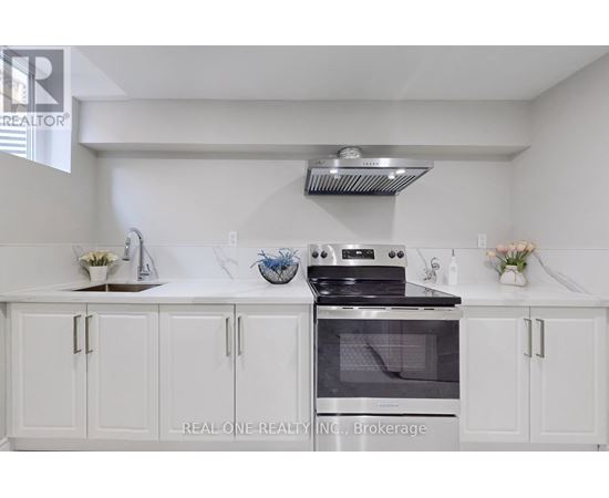 A white kitchen with a stove and cabinets.
