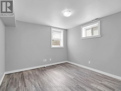 A room with a grey wall and a window.
