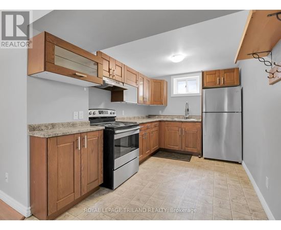 A kitchen with wooden cabinets and a black stove top oven.