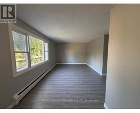 A room with a window and a white radiator on the wall.